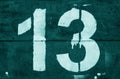 Number 13 in stencil on metal wall in cyan tone Royalty Free Stock Photo