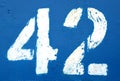 Number 42 in stencil on rusty navy blue metal wall Royalty Free Stock Photo