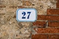 Number 27 on stone and brick wall background Royalty Free Stock Photo