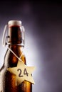 24 number on tagged christmas eve star around bottle Royalty Free Stock Photo