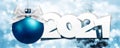 2021 number text with blue christmas ball and silver ribbon bow isolated on blurred lights background for happy new year greeting Royalty Free Stock Photo