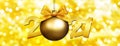 2021 number text with goden christmas ball and ribbon bow isolated on blurred lights background for happy new year greeting gift