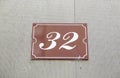 Number thirty-two on the wall of a house Royalty Free Stock Photo