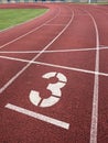 Number three. Big white track number on run rubber racetrack Royalty Free Stock Photo