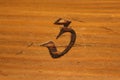 Number three branded in wood