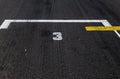 Number three position ranking close up on racing asphalt track