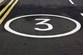 Number three painted on road