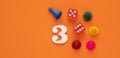 Number three in white with pieces and gambling dice - Orange eva rubber background Royalty Free Stock Photo