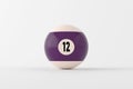 Number twelve pool ball resting on white surface