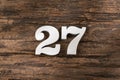 Number twenty seven 27 - White Piece on Rustic Wood Background