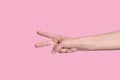 The number two. Caucasian hand, shows numbers on the fingers. on pink background Royalty Free Stock Photo