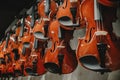A number of violins hanging on the wall in the shop Royalty Free Stock Photo