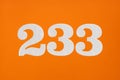 Number 233 - White digits on orange background Royalty Free Stock Photo