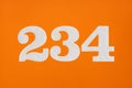 Number 234 white figures on orange background Royalty Free Stock Photo