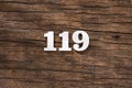 Number 119 in wood, isolated on rustic background Royalty Free Stock Photo