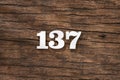 Number 137 in wood, isolated on rustic background Royalty Free Stock Photo