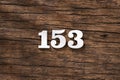 Number 153 in wood, isolated on rustic background Royalty Free Stock Photo
