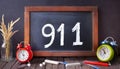 The number 911 written on chalkboard to indicate emergency