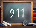 The number 911 written on chalkboard to indicate emergency