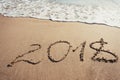 Number 2018 written on the sand in the beach Royalty Free Stock Photo