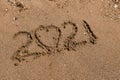 Number 2021 is written on the sand at sea...heart in the sand. Two thousand twenty one