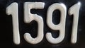 The number 1591 is written in white on a black plate. Royalty Free Stock Photo