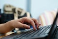 The number of a young woman pressing the keyboard of a notebook computer to use work from home Royalty Free Stock Photo