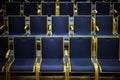 Numbered empty audience seats made of wood and blue upholstery for a theatre or concert event Royalty Free Stock Photo