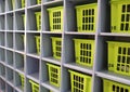 Plastic boxes in numbered wooden cells of shelving in a checkroom