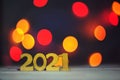 Numbers 2021 on a blurry background of holiday colorful lights. Christmas lights, beautiful bokeh. Greeting card. The concept of Royalty Free Stock Photo