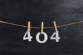 Numbers 404 with clothespins on black background. Error 404. Something wrong. Inscription from white numbers