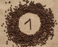 Numbers from coffee beans on burlap background Royalty Free Stock Photo