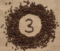 Numbers from coffee beans on burlap background Royalty Free Stock Photo