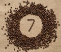 Numbers from coffee beans on burlap background Royalty Free Stock Photo