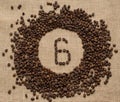 Numbers from coffee beans on burlap background Royalty Free Stock Photo