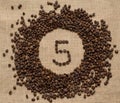 Numbers from coffee beans on burlap background Royalty Free Stock Photo