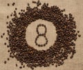 Numbers from coffee beans on burlap background Royalty Free Stock Photo