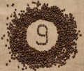 Numbers from coffee beans on burlap background Royalty Free Stock Photo