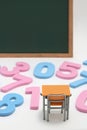 Numbers, desk and blackboard on white background. Royalty Free Stock Photo