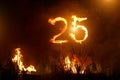 Numbers 25 on fire. Burning digits. Twenty five. Royalty Free Stock Photo