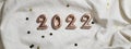 numbers 2022 on grey crumpled textiles. top view new year celebration concept.