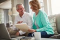 The numbers are looking good. a mature couple going over their finances at home. Royalty Free Stock Photo