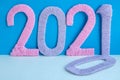 The numbers 2021 are made of pink and lilac threads on a blue and white background. The concept of a New year Royalty Free Stock Photo