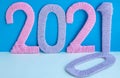 The numbers 2021 are made of pink and lilac threads on a blue and white background. The concept of a New year Royalty Free Stock Photo