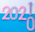 The numbers 2021 are made of pink and lilac threads on a blue and white background. The concept of a New year Royalty Free Stock Photo