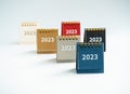 2023, numbers of new year on various colorful small desk calendars in blue, beige, yellow, grey, black and red colors.