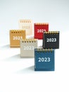 2023, numbers of new year on various colorful small desk calendars in blue, beige, yellow, grey, black and red colors. Royalty Free Stock Photo