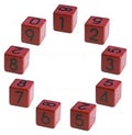 Numbers 1-2-3-4-5-6-7-8-9, one, two, three, four, five, six, seven, eight, nine written on a red wooden cube of a calendar date in Royalty Free Stock Photo