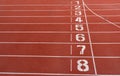 Numbers on red running track.