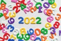 Numbers 2022 among scattered other digits in disarray on white background Royalty Free Stock Photo